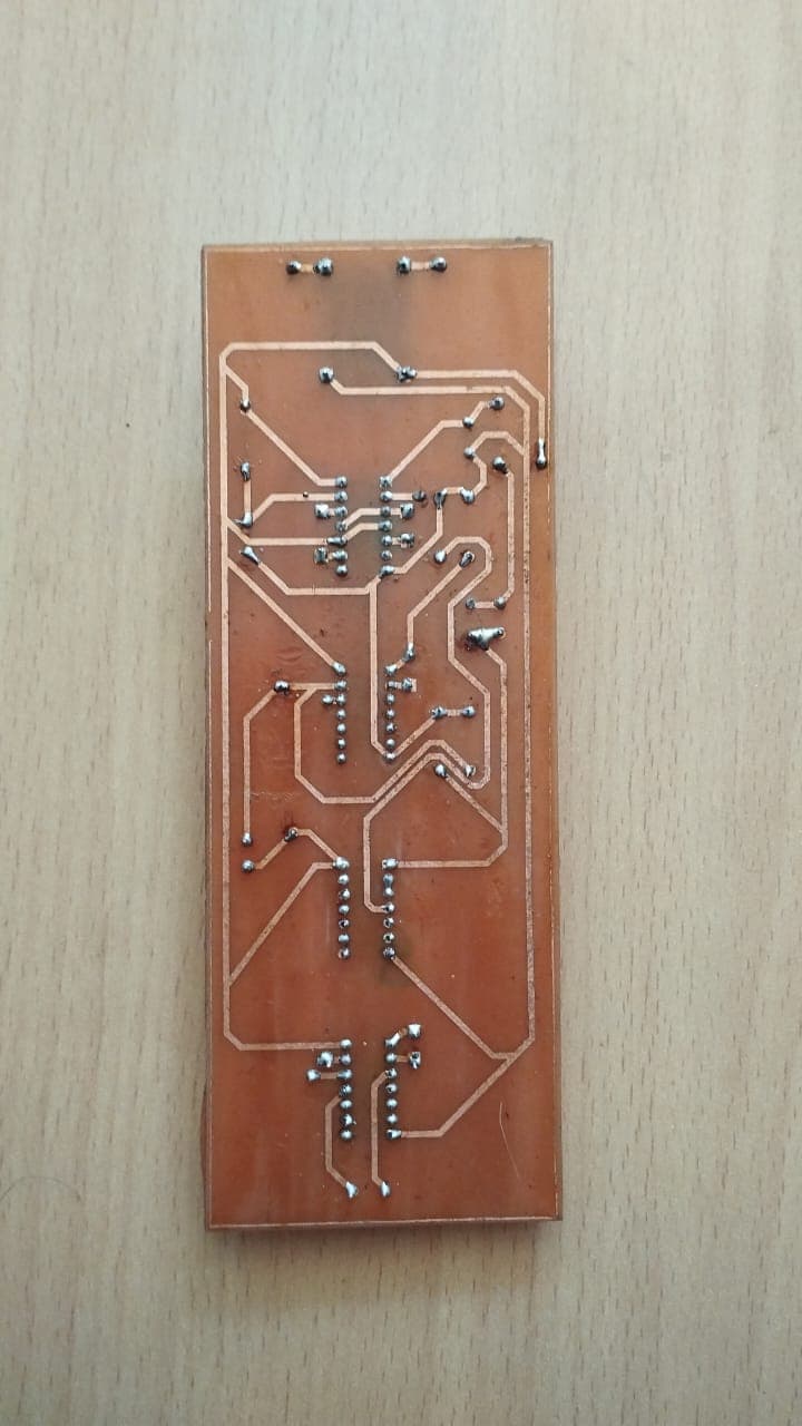 Etched copper traces and solder joints on back of the automated drawer PCB