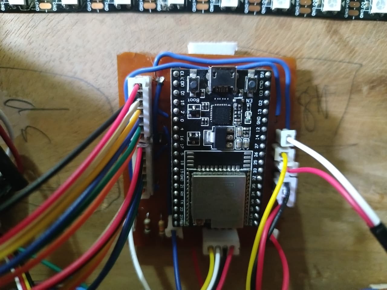 ESP32 microcontroller mounted with wiring harness for Wi-Fi and UART bridge